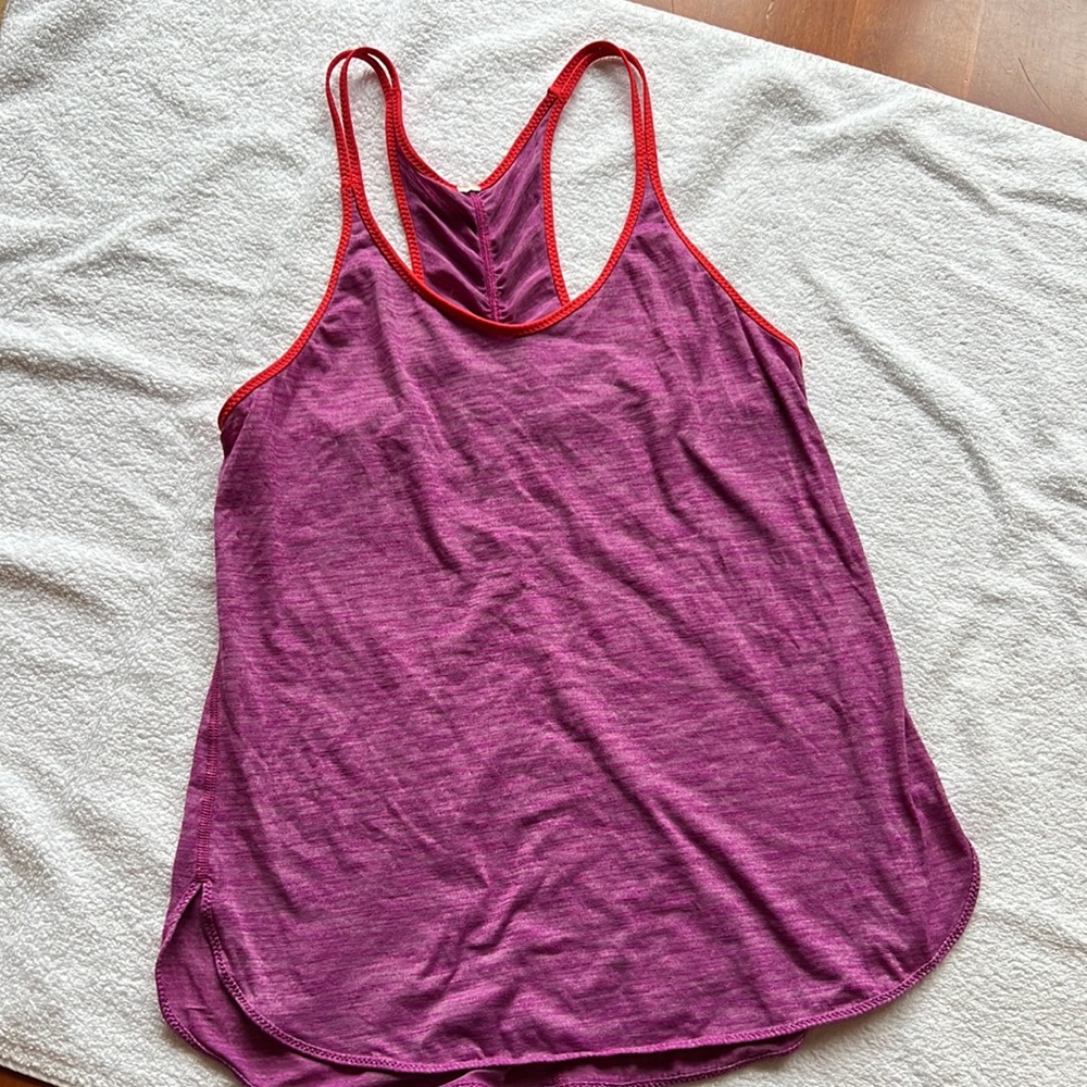 Lululemon tank size 8: medium. Heather pink with coral trim.